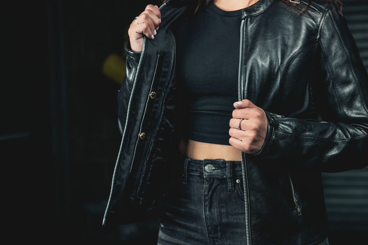 Woman wearing open Cyclone Leather Jacket, displaying interior lining and pocket configuration.