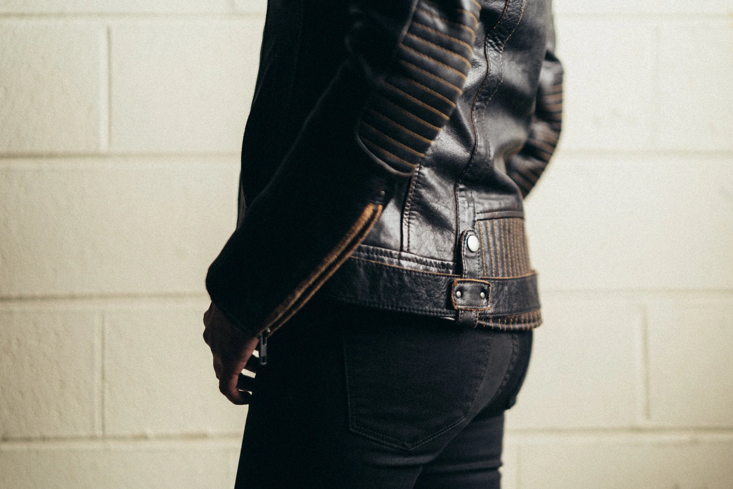 Back view of woman wearing Electra Leather Motorcycle Jacket, highlighting the design and silhouette from behind.