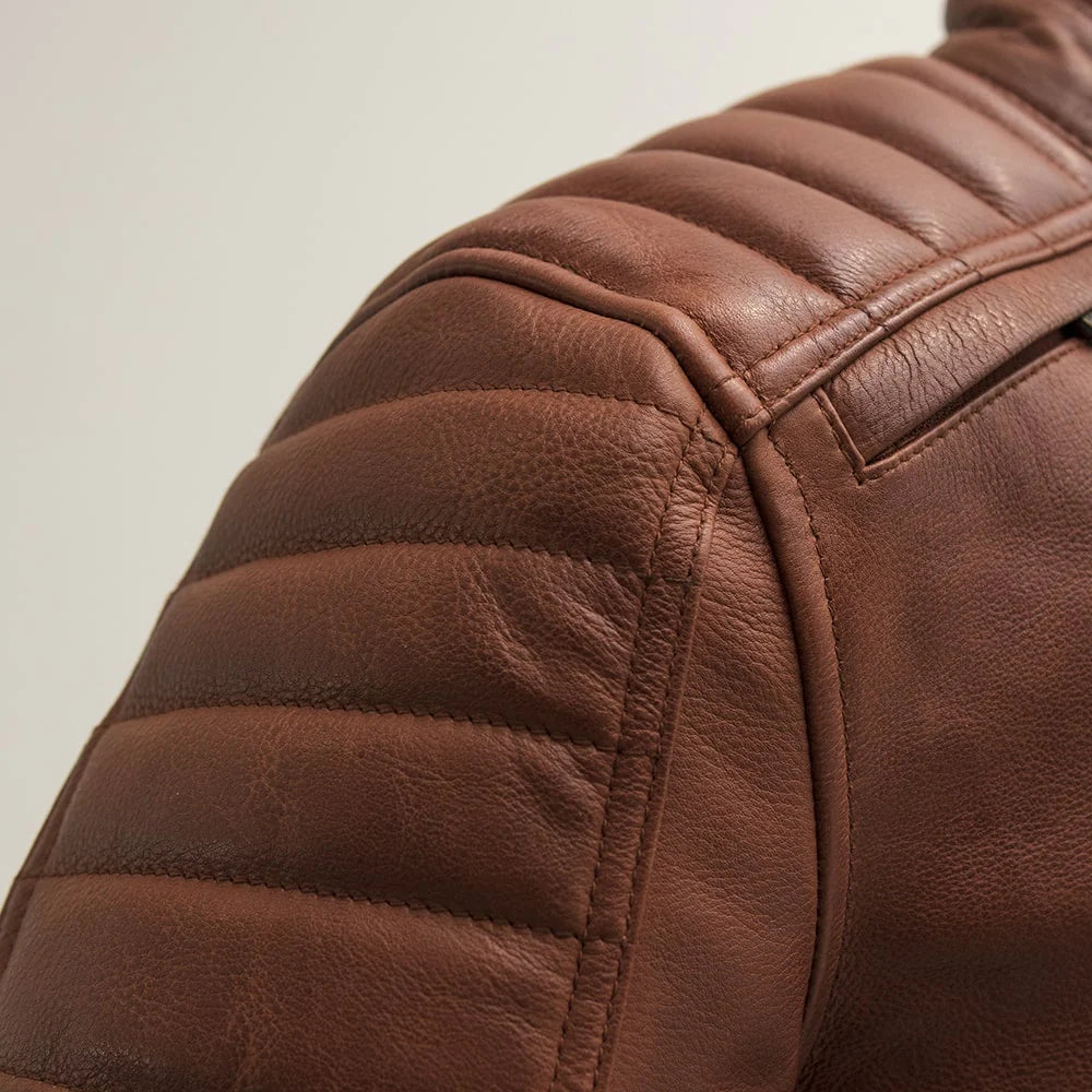 Close-up of shoulder on Crusader Men's Leather Jacket in whiskey, showcasing reinforced design and stitching detail.
