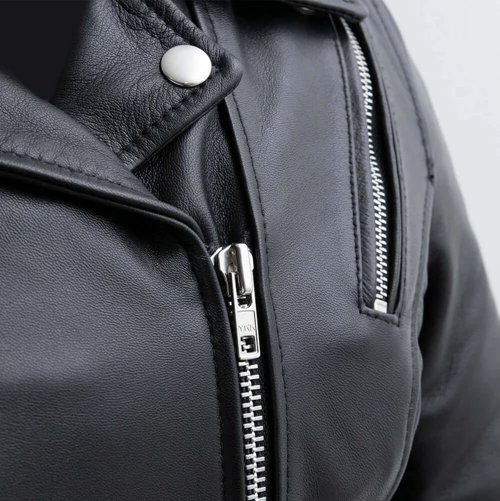 Close-up of front zipper on Bloom Women's Leather Motorcycle Jacket, showcasing sturdy metal hardware and detailed stitching.