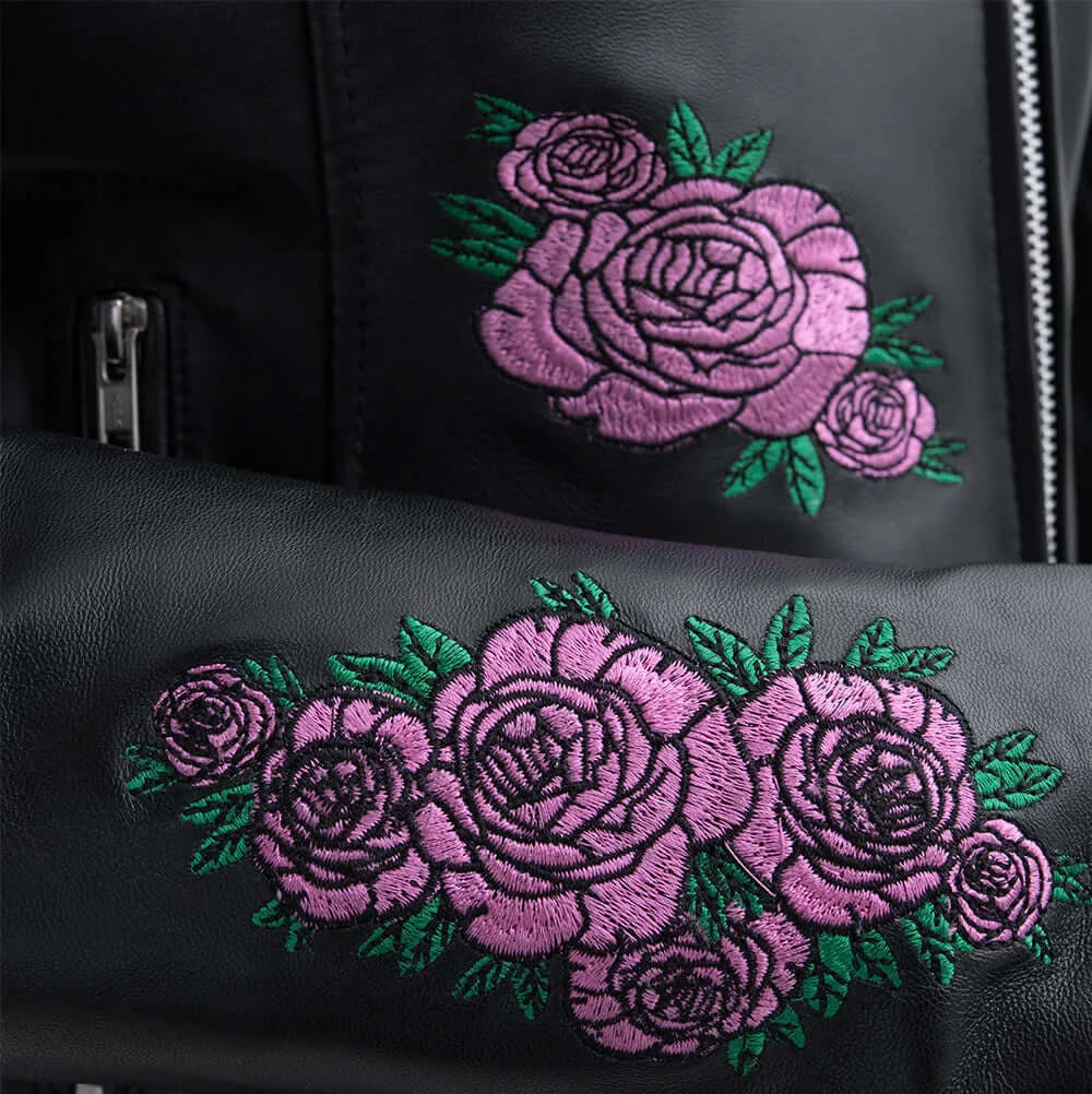 Close-up of Bloom logo on Women's Leather Motorcycle Jacket, emphasizing intricate design and branding.